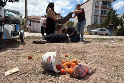 Yerde yatan yaralı kadına mont ile gölgelik yaptılar
